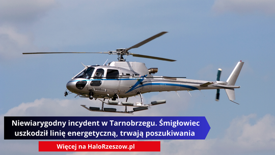 Srebrno-niebieski śmigłowiec leci na tle nieba. Na dole grafiki znajduje się napis: „Niewiarygodny incydent w Tarnobrzegu. Śmigłowiec uszkodził linię energetyczną, trwają poszukiwania” oraz pasek z adresem serwisu HaloRzeszow.pl.