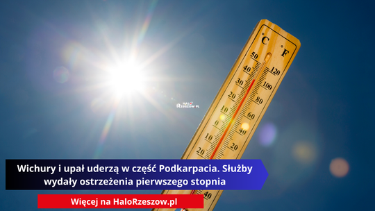 Pionowy drewniany termometr na tle intensywnie błękitnego nieba z jaskrawym słońcem w lewym górnym rogu. Słup cieczy w termometrze wskazuje temperaturę około 30 stopni Celsjusza (°C) i 86 stopni Fahrenheita (°F).